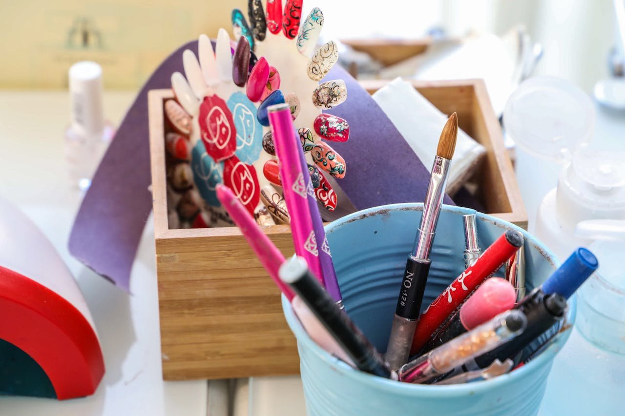 engagements-photography-02 Vibrant desk scene with colorful makeup and nail art tools in containers.